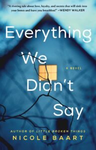 Book cover for Everything We Didn't Say by Nicole Baart. Image on cover shows yellow light illuminating one upstairs room in a blue two-story house at dusk or dawn. 